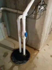 Professional basement sump pump and interior drainage system installed for waterproofing protection in a Michigan basement
