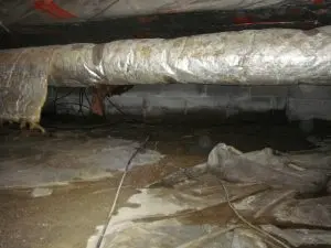 Encapsulated crawlspace with standing water and high humidity showing why crawlspace encapsulation needs mechanical ventilation.