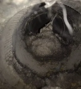Dirty air duct interior showing accumulated dust and debris, highlighting potential fire hazards and health risks associated with neglected air ducts.
