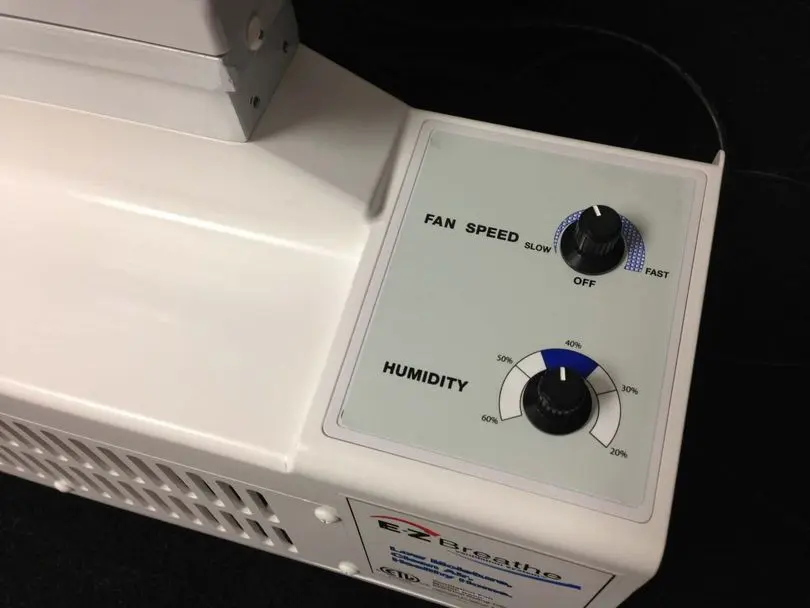 EZ Breathe air exchange system controls showing fan speed and humidity settings for a basement dehumidifier vs air exchange system comparison.