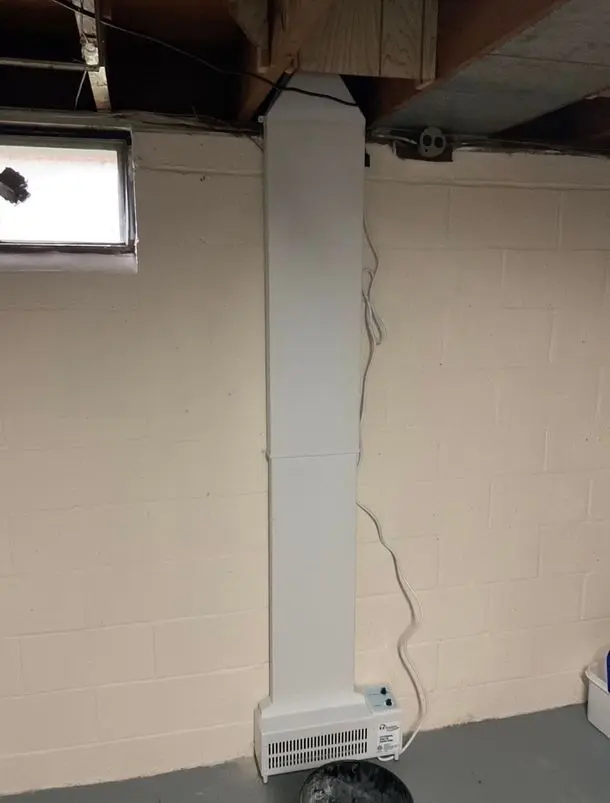 Basement ventilation system installed on a white wall, designed to improve indoor air quality by reducing moisture and allergens.