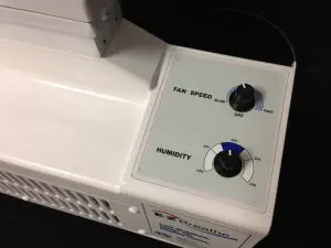 EZ Breathe air exchange system controls showing fan speed and humidity settings for a basement dehumidifier vs air exchange system comparison.