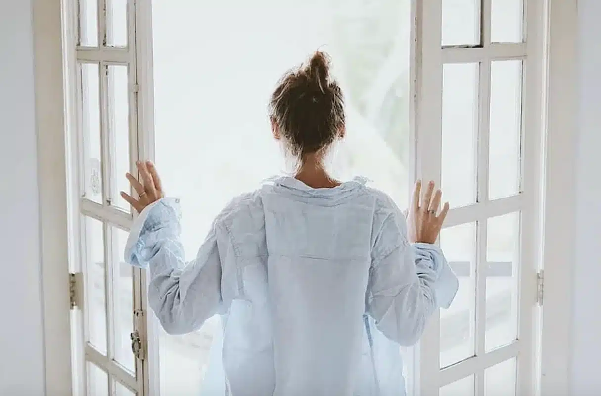 woman-opening-doors-in-morning-for-fresh-air-macedonia-ez-breathe-oh-1