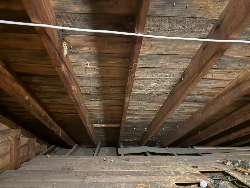Exposed crawl space framing and floor joists showing an area where sagging floor joist repair in NJ may be needed
