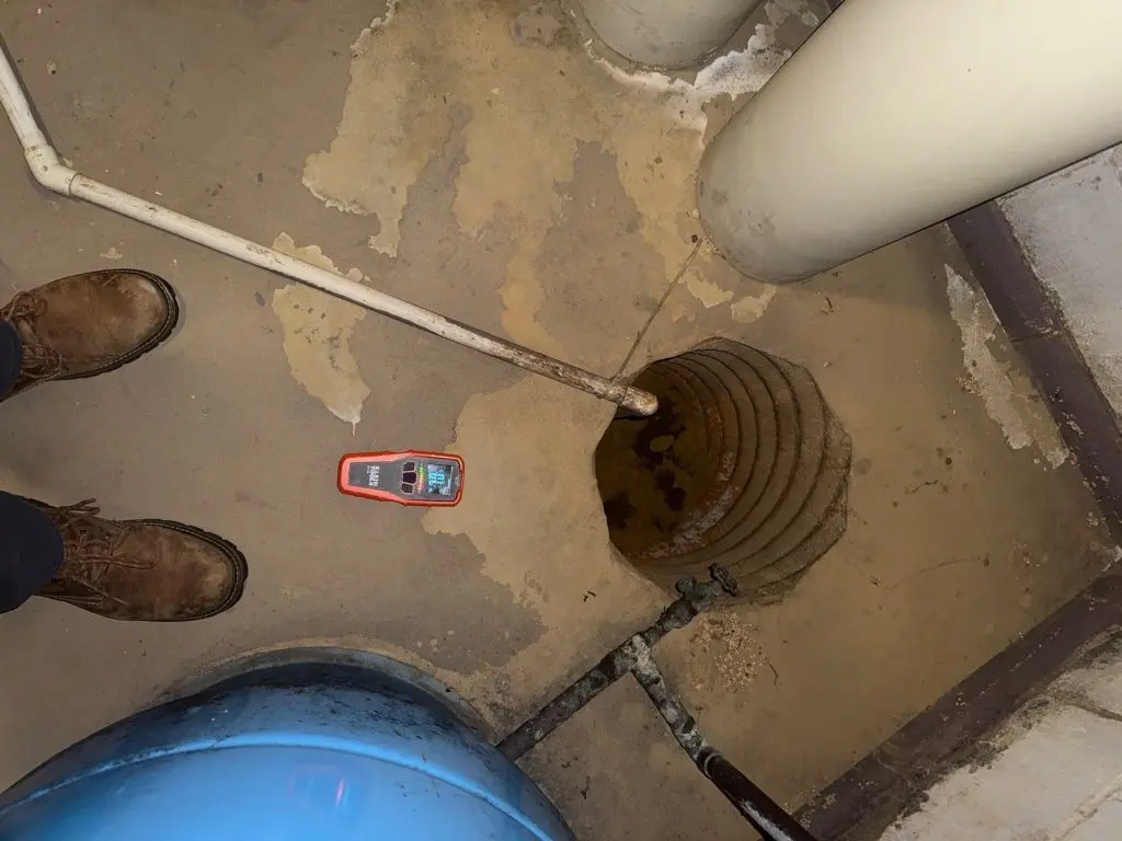Basement sump pit inspected for water intrusion in a New Jersey home