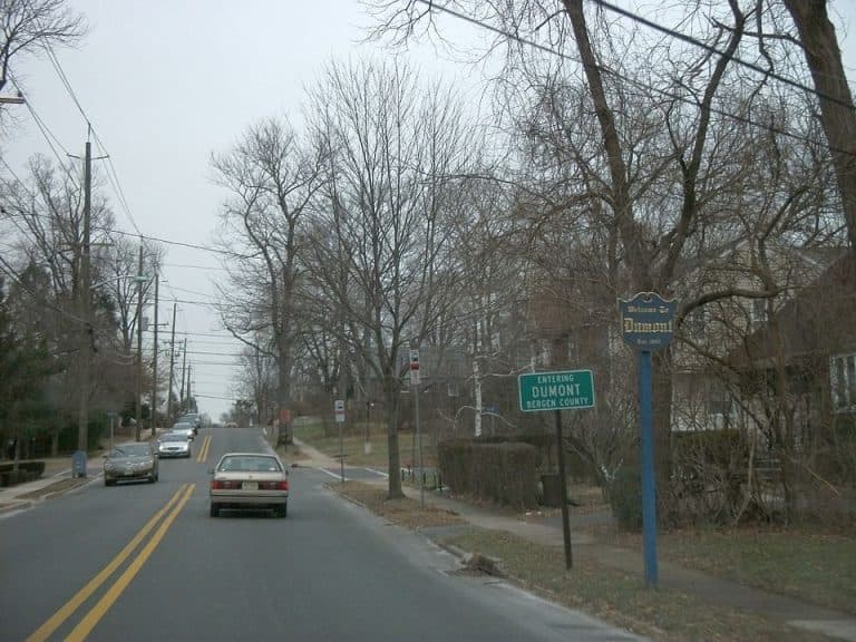 Entering Dumont, Bergen County sign on a tree-lined street, showcasing residential area and vehicles, reflecting local community context for HealthyWay Waterproofing services.