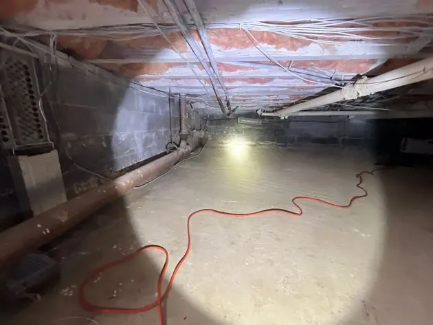Unencapsulated crawl space with exposed pipes and insulation, potential mold remediation project in New Jersey