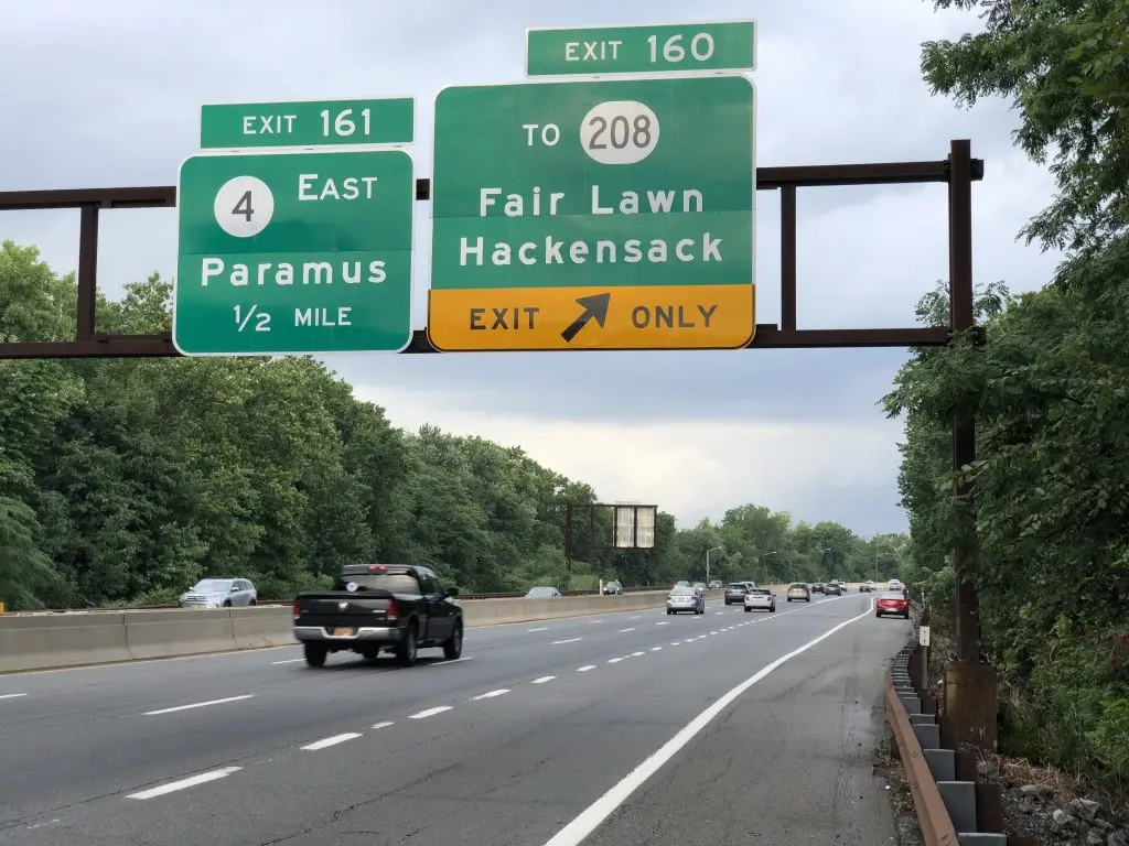 Road sign indicating Rochelle Park exit and directions to Paramus and Hackensack, NJ.