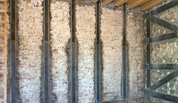 Carbon fiber foundation repair system installed on walls, showcasing structural reinforcement for foundation stability and protection against moisture damage.