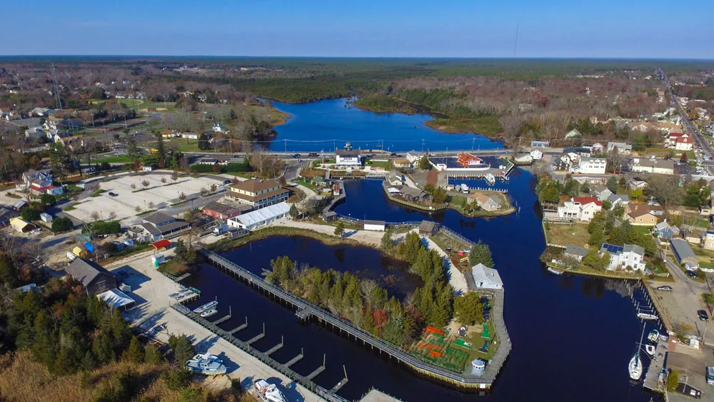 Aerial view of Tuckerton, NJ, featuring waterfront homes, marinas, and green spaces, highlighting the area serviced by Healthy Way Waterproofing & Mold Remediation.