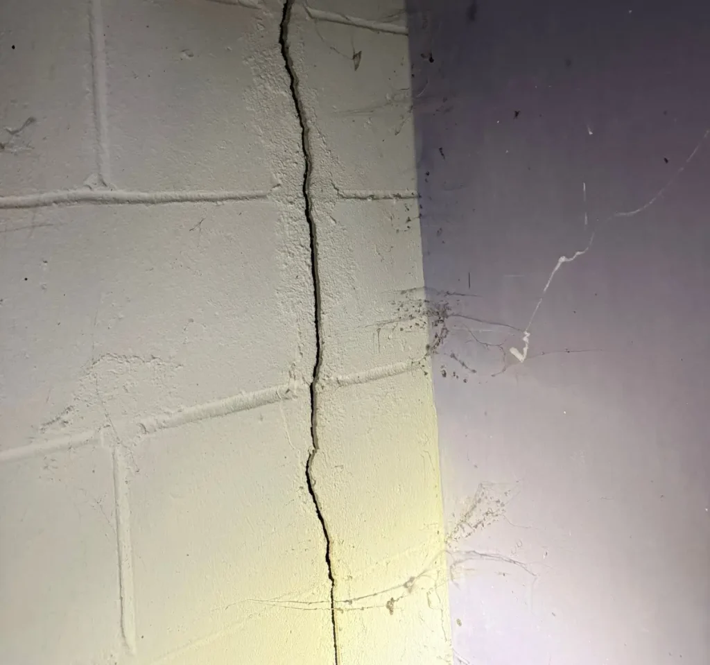 Basement foundation crack with water intrusion and seepage, contributing to mold growth in New Jersey