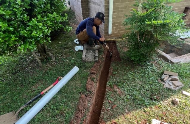 Waterproofing contractor installing drainage solution