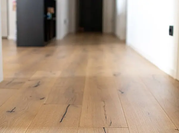 Sloping wooden floors indicating potential foundation settlement and crawl space sagging.
