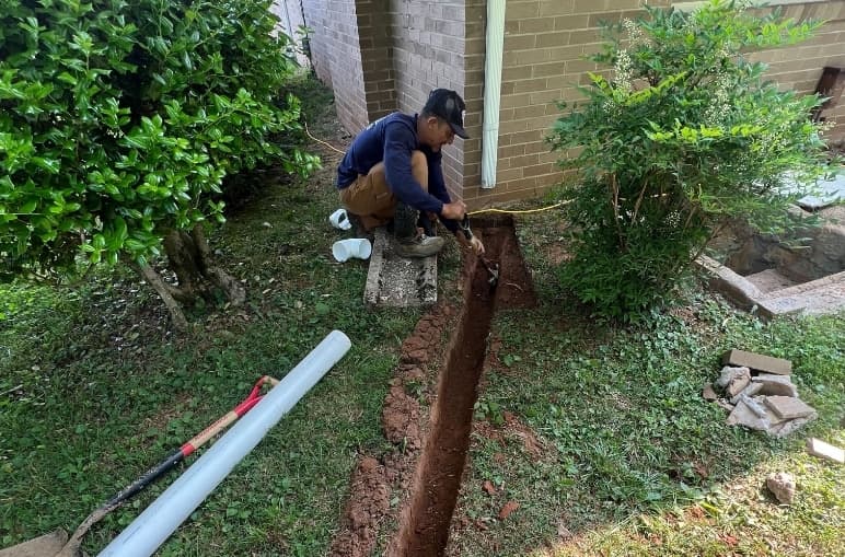 Professional waterproofing contractor installing drainage solutions