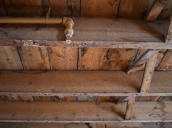 Crawl space framing with wood stress and popping sounds, indicating foundation movement.