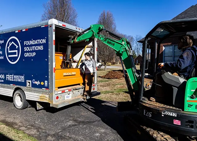Foundation Solutions Group truck and equipment at a foundation repair job site in South Central Kentucky.