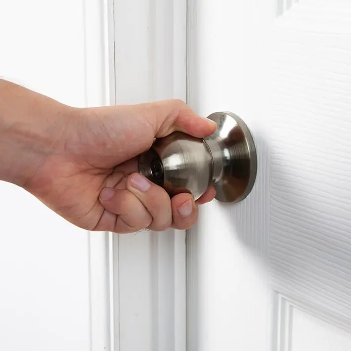 Sticking door handle illustrating foundation issues and potential property value decrease.
