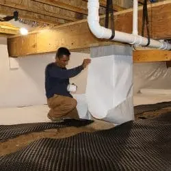 Crawl space encapsulation with vapor barrier and liner installation for moisture control.