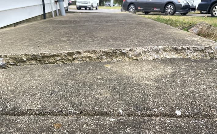 Uneven concrete driveway with significant cracking and displacement in Bowling Green, KY.