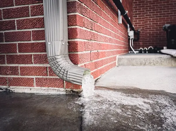 gutter draining a ton of water and damaging a sidewalk