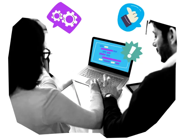 Two colleagues reviewing code on a laptop