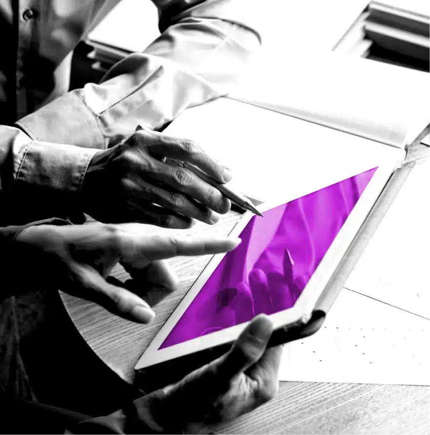 Two professionals reviewing data on a tablet