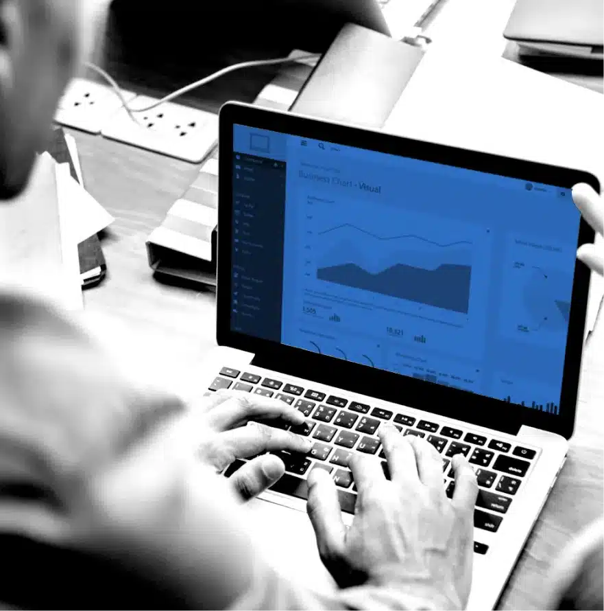 Person typing on laptop with business analytics dashboard