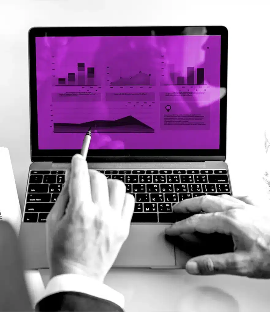 Hands analyzing data charts on laptop screen