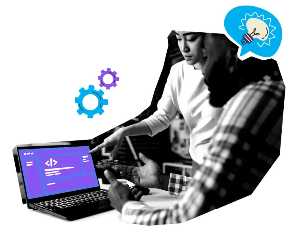 Two people collaborating on laptop with code