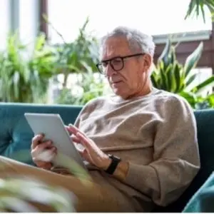 Father with dementia playing on a tablet