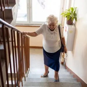 older woman walking up stairs