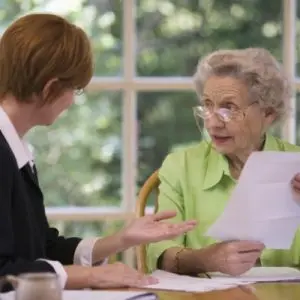 Elderly woman talking with her attorney