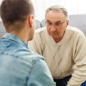 Son talking to father with dementia