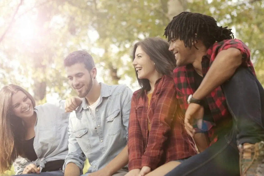 A group of people sitting on top of a bench.