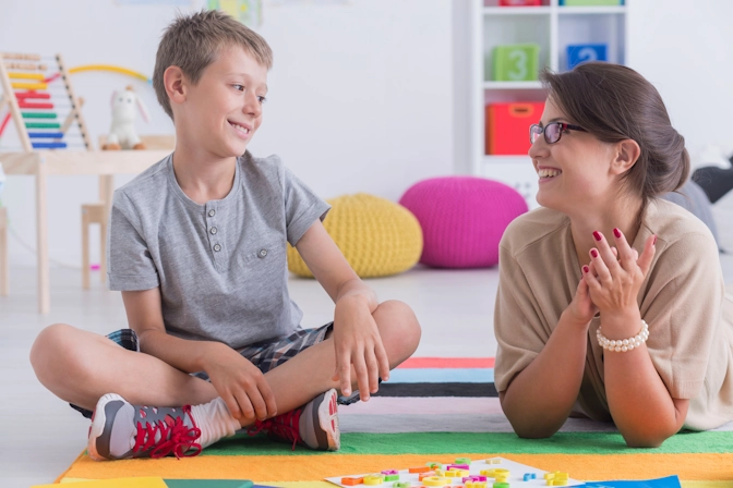 A boy participates in play therapy with a registered play therapist