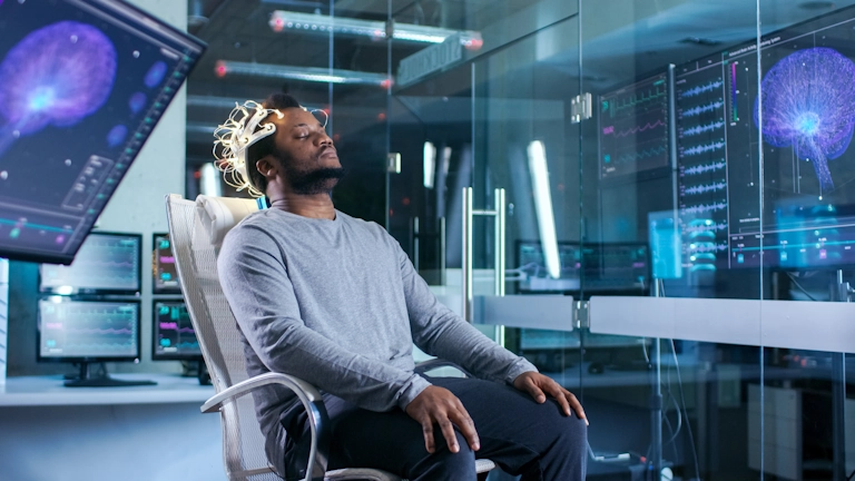 A man relaxes while participating in neurofeedback therapy at Armstrong Family Counseling