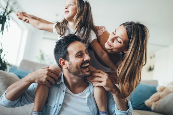 A happy family smiles and plays together