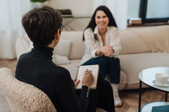 A woman speaks with a therapist in her office as part of a court assessment