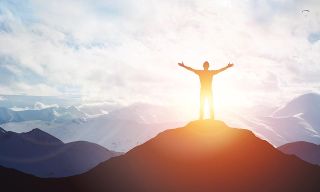 A hiker welcomes the sunrise, free from depression