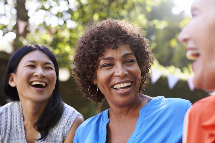 A group of friends talk and laugh together, free from depression