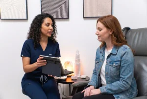 A ketamine nurse discusses treatment with a patient