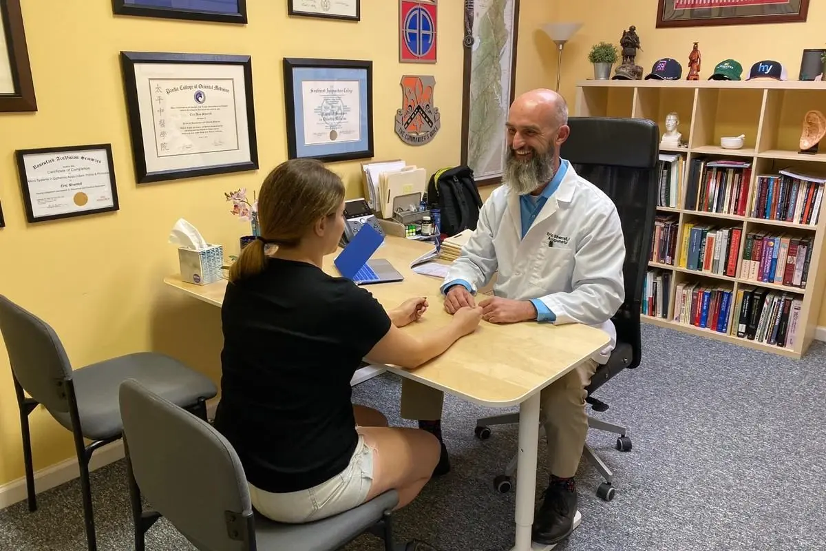 Augusta Acupuncture Clinic | What to Expect at Your First Acupuncture Visit in Augusta, GA Dr. Eric Sherrell speaking with a patient during a consultation at Augusta Acupuncture Clinic
