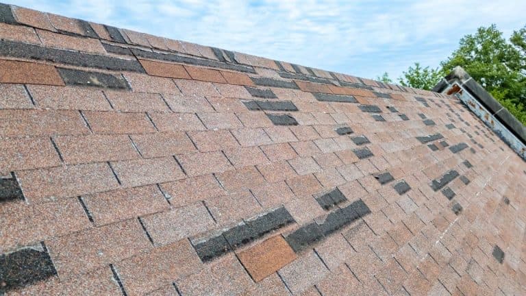 Roof with missing shingles from storm damage and old age in Wayzata, MN