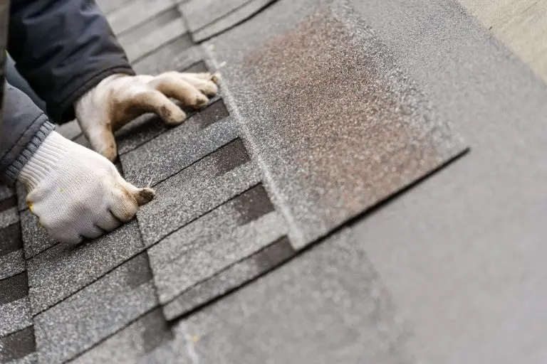 hand installing asphalt shingles on a roof, Wayzata, Minnesota