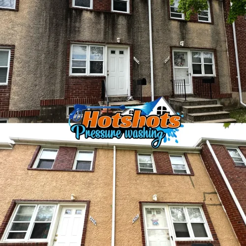 Townhouse exterior cleaned of heavy black stains through pressure washing. Includes Hotshots Pressure Washing logo