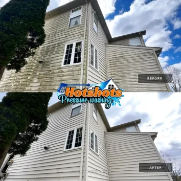 Three-story house siding cleaned of green algae and buildup with pressure washing. Hotshots Pressure Washing logo shown