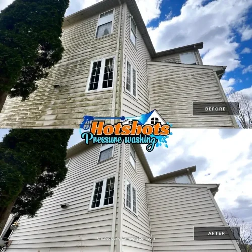 Three-story house siding cleaned of green algae and buildup with pressure washing. Hotshots Pressure Washing logo shown
