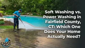 Pressure washing technician cleans a poolside wooden deck, revealing a clear dirty-to-clean transition beside a landscaped residential swimming pool.