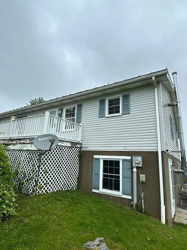 pro pressure works is cleaning a two story home exterior with focus on the siding and surrounding vegetation for optimal results