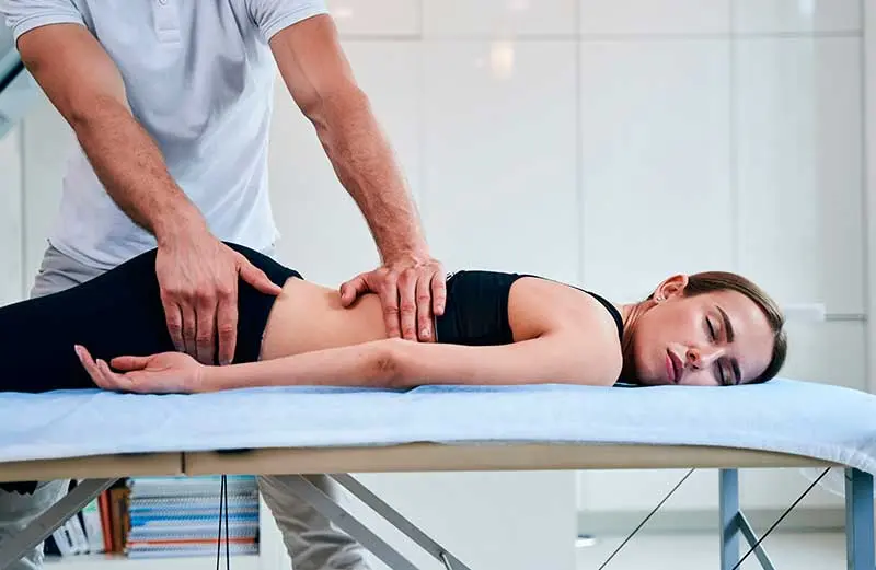 Chiropractor providing spinal adjustment and treatment for musculoskeletal injuries.